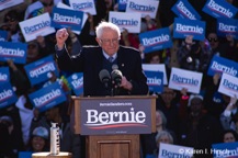 Bernie Sanders lifting fist while making a point